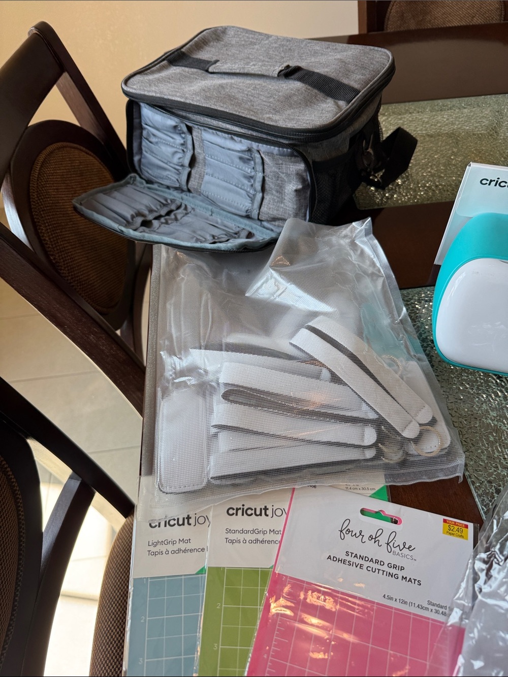 Cricut accessories bundle with gray carrying case and teal machine